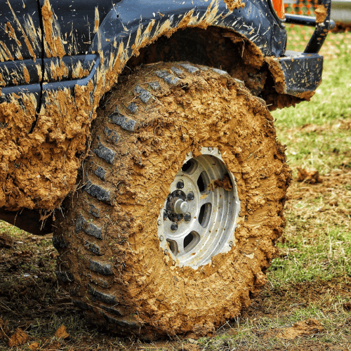 Tire Streets Accelera Badak X-Treme Ultra Aggressive Mud Terrain Tire caked in mud