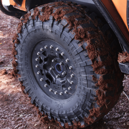 Tire Streets Accelera Badak X-Treme aggressive mud terrtain tire covered in dirt