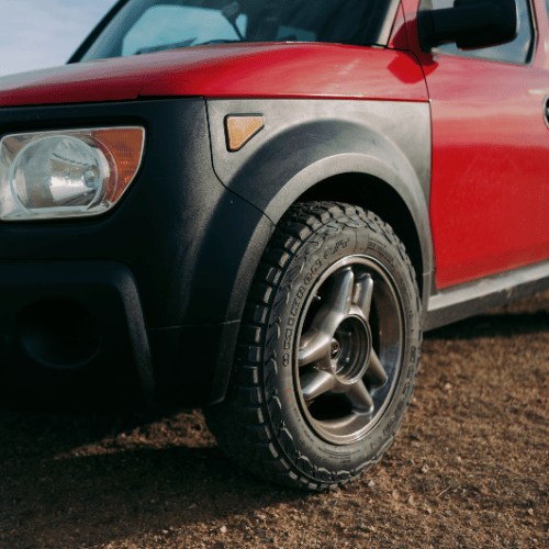 Tire Streets Accelera Omikron CT All Terrain Light Truck Tire on a red honda element in the desert close up
