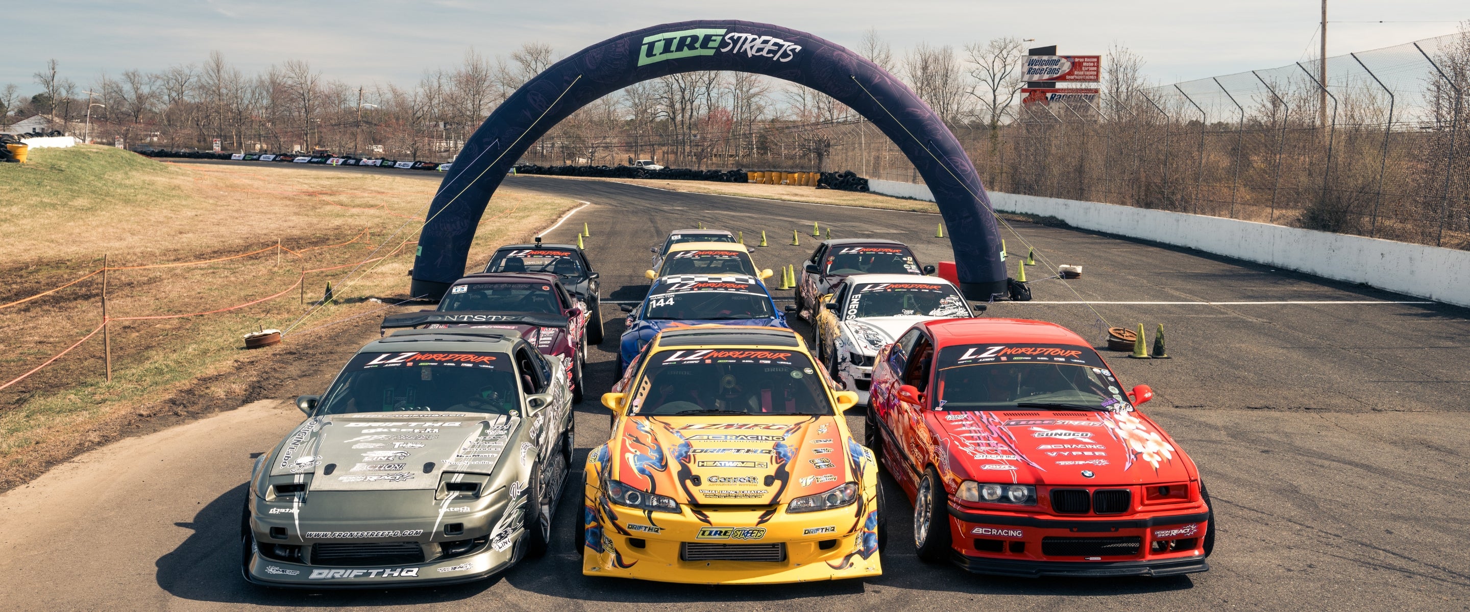 Tire Streets Driver Cars on track under Tire Streets banner